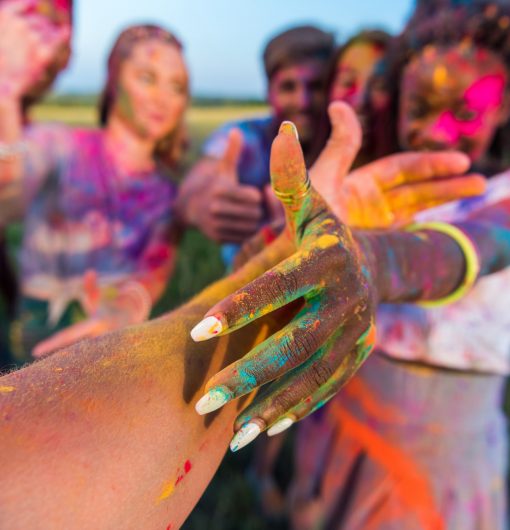 Happy Young Multiethnic Friends Having Fun With Colorful Powder at Holi Festival of Colors